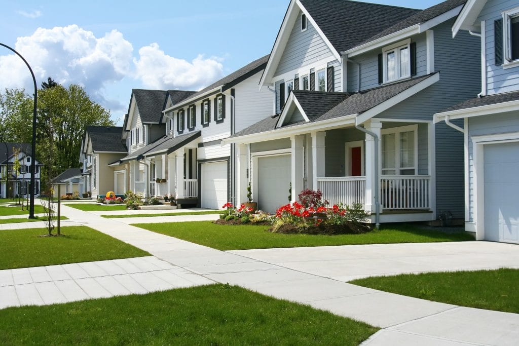 Stock image of a row of houses that each need their own radon testing.